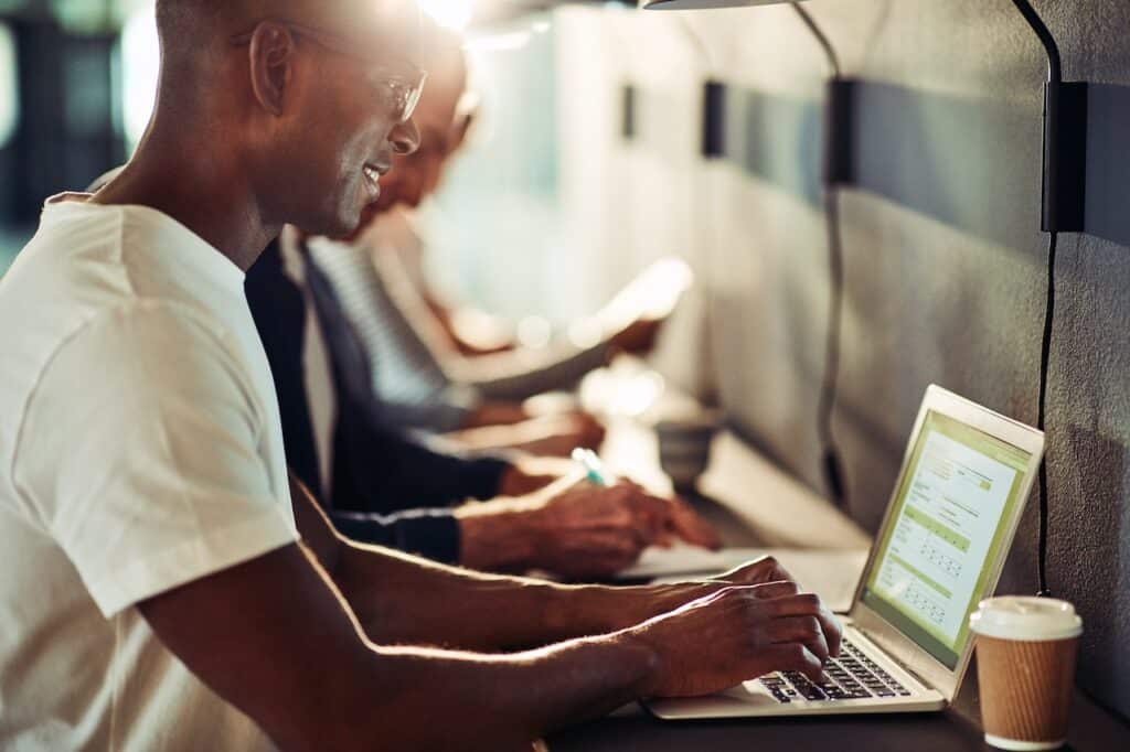 man working on laptop at cafe